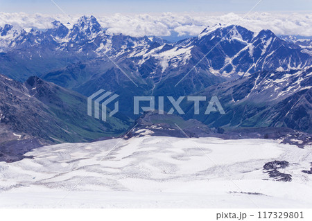 mountain landscape, view from highland snow slope to green valleys, view from Mount Elbrus to the Main Caucasian Range 117329801