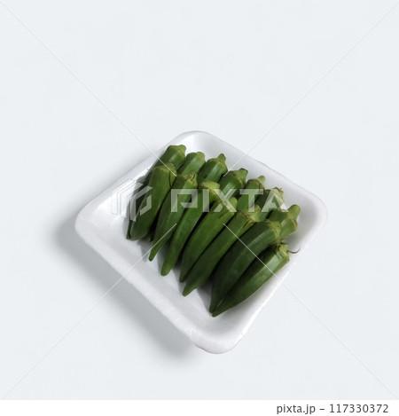 fresh okra pods on white background, vibrant green colour, inviting texture. crisp & delicious, perfect for culinary creations. 117330372