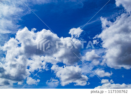 Magnificent cumulus clouds high in blue sky Magnificent cumulus clouds high in blue sky 117330762