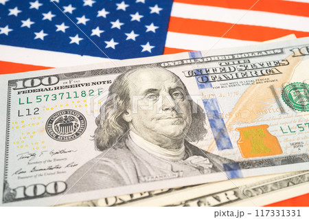 US dollar banknotes on USA America flag background, Business and finance. US dollar banknotes on USA America flag background, Business and finance. 117331331
