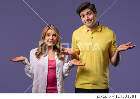 Confused man woman, couple shoulders up - can't help, makes gesture of dont know 117331391