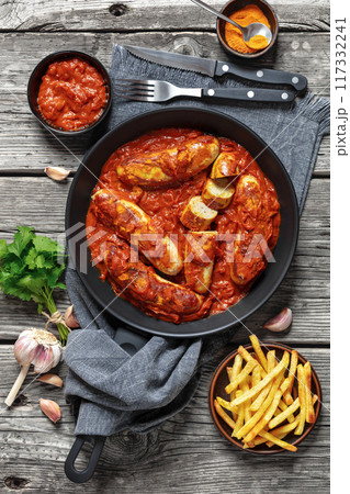 German Currywurst, pork sausages in a curry sauce German Currywurst, pork sausages in a curry sauce 117332241