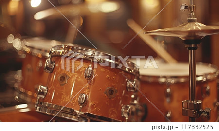 Jazz drums with drumsticks poised above the snare drum, percussion instruments in a cozy studio 117332525