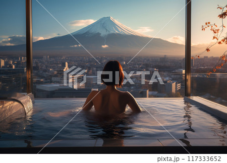 young beautiful woman in hot jakuzzi bath with water on winter mountain background, Fuji peak 117333652