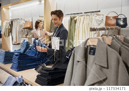 Women enjoying sale in store, shock price on new arrival concept Women enjoying sale in store, shock price on new arrival concept 117334171