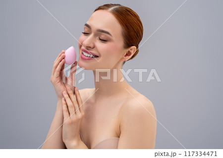 Pretty ginger caucasian woman using absorbing face sponge and smiling 117334471