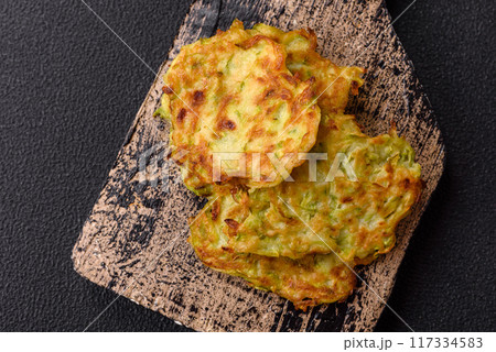 Vegetable zucchini fritters with garlic, salt, spices and herbs 117334583