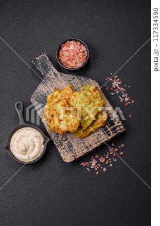 Vegetable zucchini fritters with garlic, salt, spices and herbs 117334590