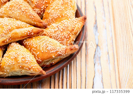 Homemade triangle puff pastry with meat on rustic background . Samosa 117335399