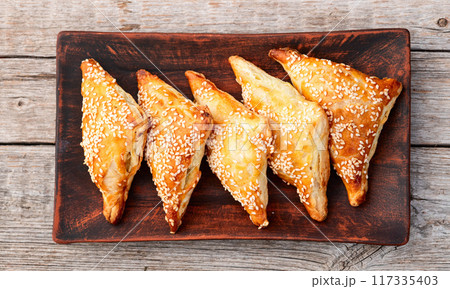 Homemade triangle puff pastry with meat on rustic background . Samosa 117335403