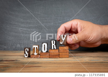 STORY. Wooden letters, alphabet blocks on steps. development and growth concept STORY. Wooden letters, alphabet blocks on steps. development and growth concept 117335891