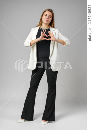 Woman Making Heart With Hands on gray background Woman Making Heart With Hands on gray background 117340923