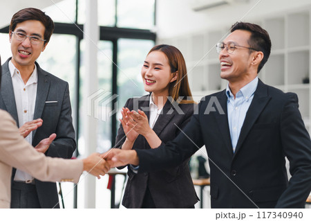 Successful business people shaking hands during a meeting in the office. Successful business people shaking hands during a meeting in the office. 117340940