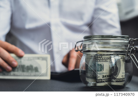Man hands counting expenses banknotes of dollar cash on calculator. Close up of hands unrecognizable Businessman. Save up budget investment concept. American bucks fund savings 117340970
