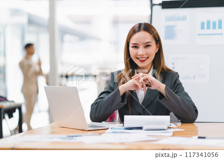 Confident asian businesswoman using laptop in meeting room. 117341056