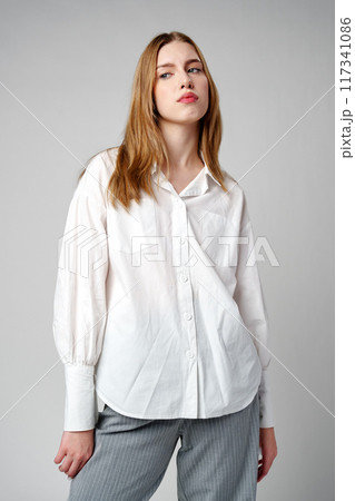Young Woman Exhibiting a Pensive Sad Expression in a Studio 117341086