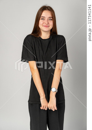 Young Woman in Black Shirt and Black Pants in Studio 117341141