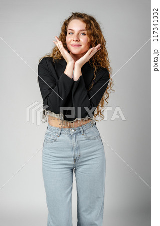 Woman With Curly Hair Standing on Gray Background 117341332