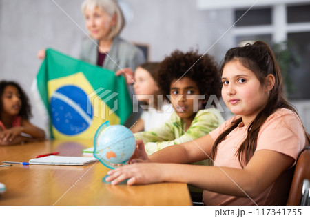 Mature female teacher tells the pupils the history of Brazil Mature female teacher tells the pupils the history of Brazil 117341755