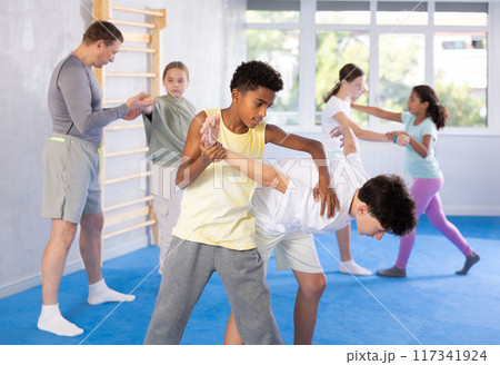 Two boys practicing self-defense techniques Two boys practicing self-defense techniques 117341924