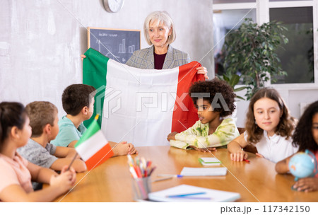 students listen to woman teacher who talks about Italy students listen to woman teacher who talks about Italy 117342150
