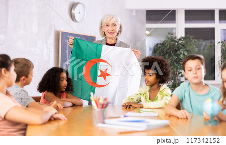 students listen to woman teacher who talks about Algeria 117342152