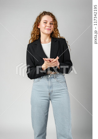 Young Woman With Curly Hair Portrait against gray background 117342195