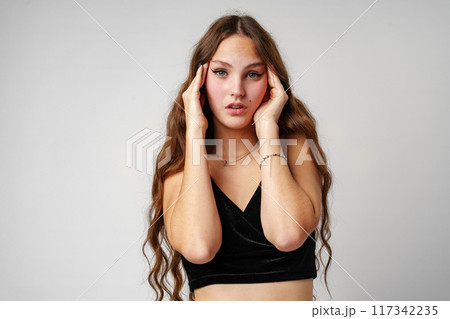 Woman in Black Top Holding Hands to Face Woman in Black Top Holding Hands to Face 117342235