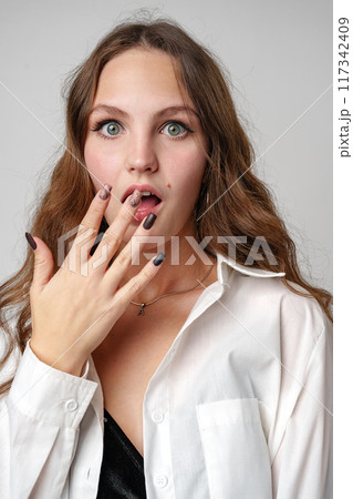 Woman Holding Hands Up to Mouth Woman Holding Hands Up to Mouth 117342409