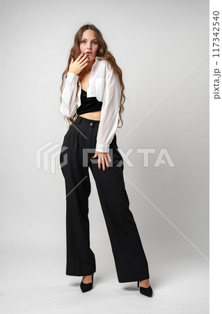 Woman Holding Hands Up to Mouth 117342540