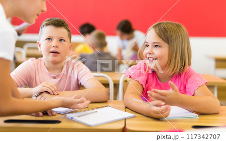 Interested preteen pupils discussing learning material in groups Interested preteen pupils discussing learning material in groups 117342707