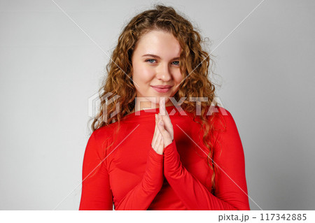 Young Woman With Curly Hair Portrait against gray background Young Woman With Curly Hair Portrait against gray background 117342885