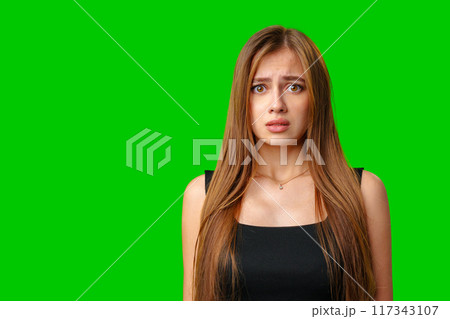 Young Woman With Worried Expression Against Green Screen Background 117343107