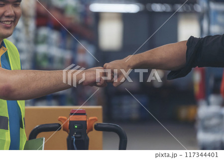 Diversity Teamwork Warehouse worker fist bump together trust partner. Engineer man, women hands partnership. Coworker colleague logistics Warehouse agreement. Multiracial Two people fist bump partner 117344401
