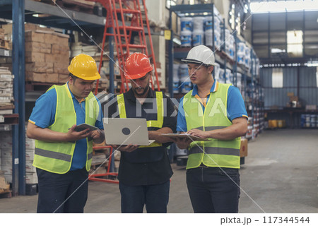 Warehouse management multiracial team partner engineer man work together checklist stock control. Warehouse worker teamwork diversity men using laptop logistics counting products store inventory. 117344544
