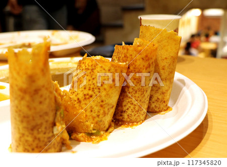 A plate full of delicious Indian pizza Dosa wraps with sambhar a 117345820