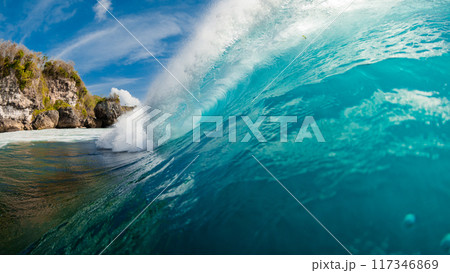 Barrel wave in ocean. Blue wave with sunlight. Panoramic view Barrel wave in ocean. Blue wave with sunlight. Panoramic view 117346869