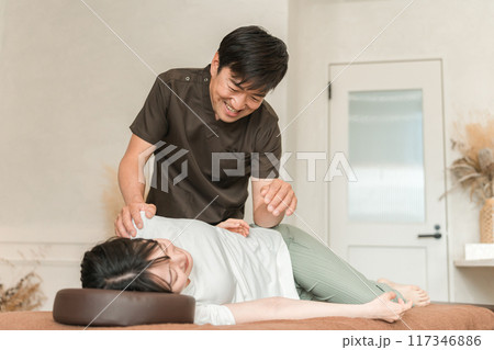 骨盤矯正・整体院・整骨院・マッサージに通う女性と整体師・セラピスト 骨盤矯正・整体院・整骨院・マッサージに通う女性と整体師・セラピスト 117346886
