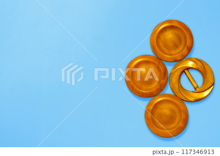 Orange copper ginger wooden circles buttons on blue. Elements, art decoration 117346913