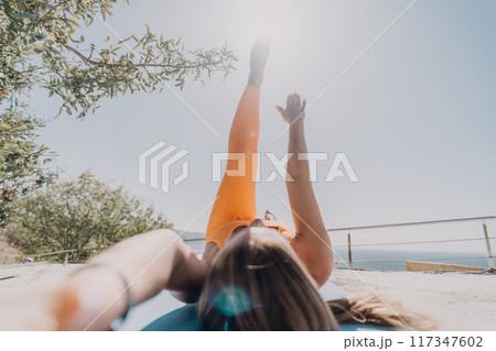 Woman Exercising on a Rooftop with a Stunning View 117347602