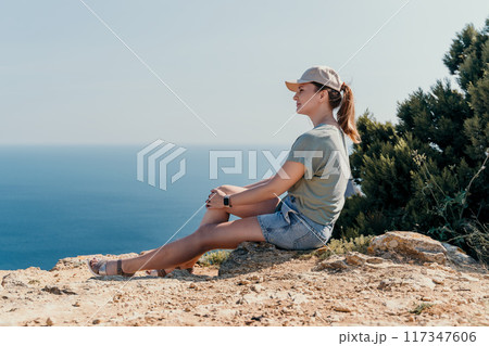 Woman in a Cap Contemplating the Ocean 117347606