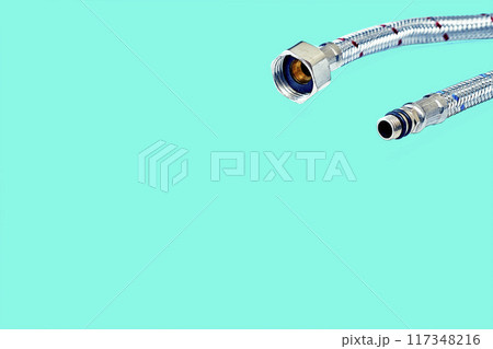 Plumbing. Flexible metal stainless steel faucet hoses on azure blue Plumbing. Flexible metal stainless steel faucet hoses on azure blue 117348216