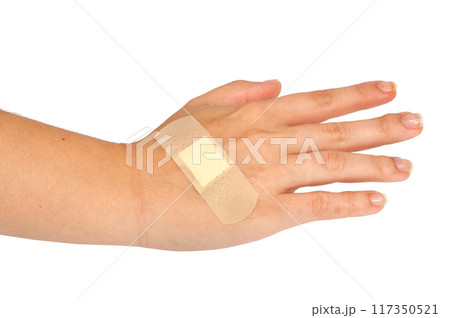 medical plaster or patch on hand isolated on the white 117350521