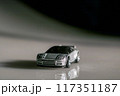 A vibrant toy car proudly perched atop a table, ready for its next adventure. 117351187