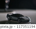 In the shadows, a toy car waits patiently, a symbol of childhood dreams and possibilities. 117351194