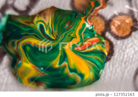 Abstract background of colored paint mixing in water, close-up	 117352163
