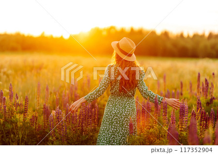 Beautiful woman in style dress on blooming fragrant lavender fields. Nature, vacation, lifestyle 117352904
