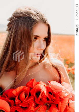 Woman poppies field. portrait happy woman with long hair in a poppy field and enjoying the beauty of nature in a warm summer day. Woman poppies field. portrait happy woman with long hair in a poppy field and enjoying the beauty of nature in a warm summer day. 117353054