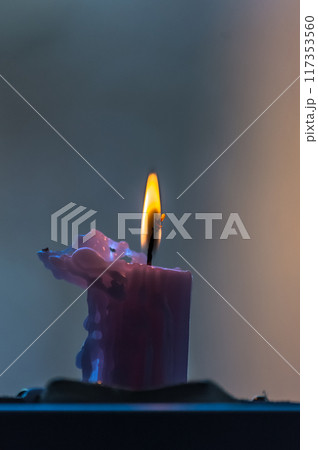 Burning candle in a dark room, shallow depth of field. 117353560