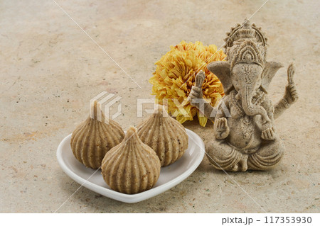 Ganesh Chaturthi Festival. Ganesha statue with modak sweets 117353930
